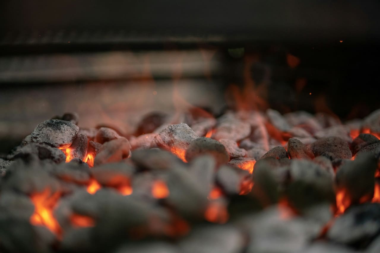 Glowing embers and burning wood in a fire pit